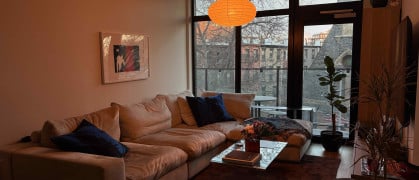 A cozy living room lit in orange light.